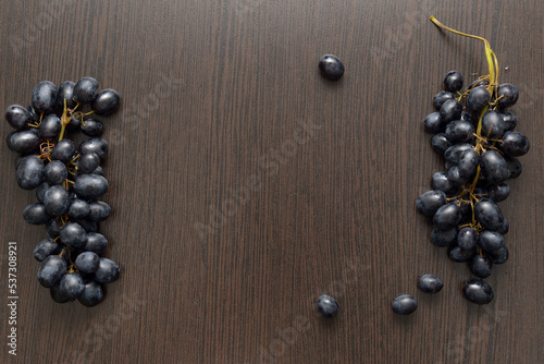 black grapes on a wooden brown table