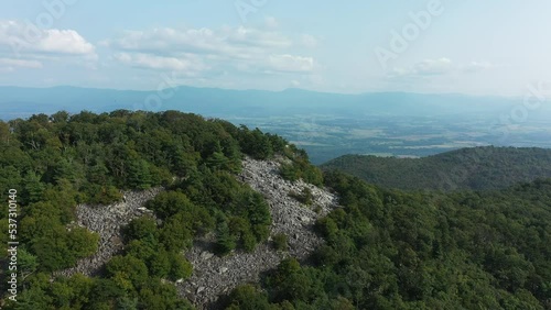 Counterclockwise orbiting aerial shot of Duncan Knob in the Massanutten Range in George Washington National Forest in Page County, VA. The Shenandoah Valley landscape is seen.