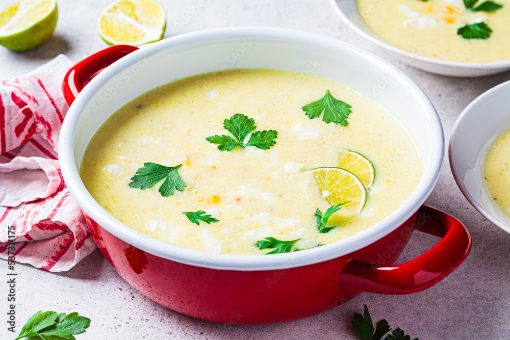 Corn soup in red pot. Vegan recipe concept. Corn soup in red pot. Vegan recipe concept.