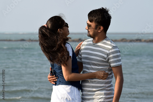 Closeup of young couple hugging and holding each other. Asian couple enjoying the valentine vacation at the sea beach in honeymoon