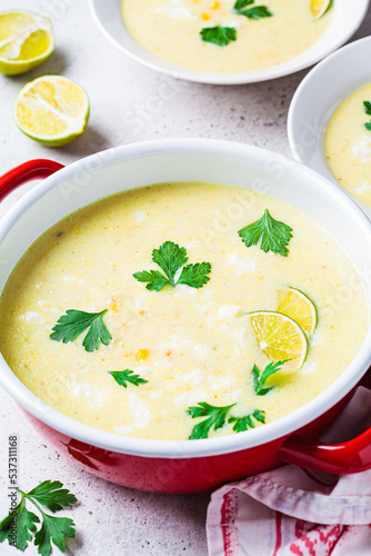 Corn soup in red pot. Vegan recipe concept.