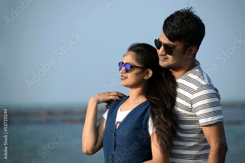 Closeup of a newly married couple holding each other in the sea beach. Valentine time for boyfriend and girlfriend.