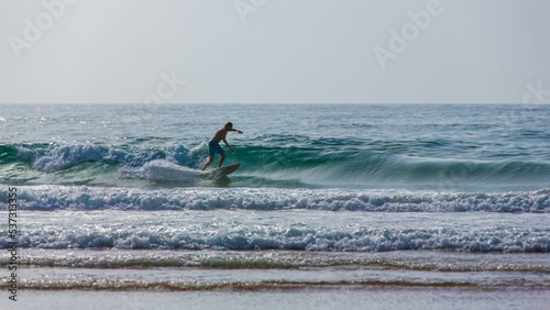 A man is surfing on a surfboard in Agadir beach