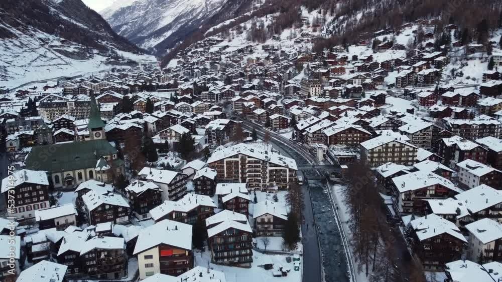 Zermatt, Switzerland: Aerial drone footage of the famous Zermatt traditional village in the Swiss alps in winter. 