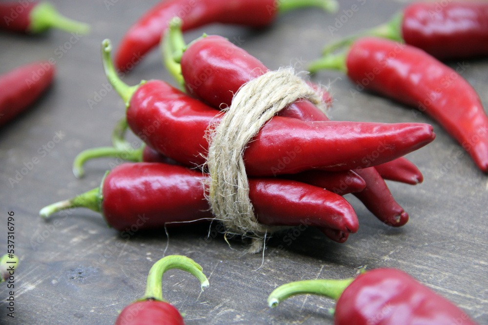 Red Spicy Chili Pepper on wooden background.
