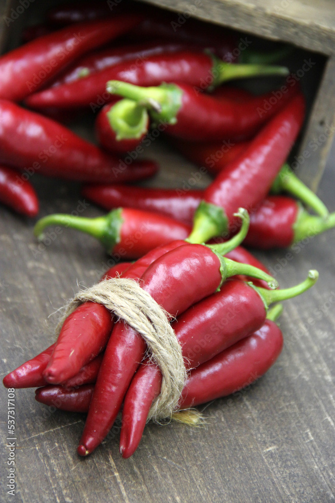 Red Spicy Chili Pepper on wooden background.