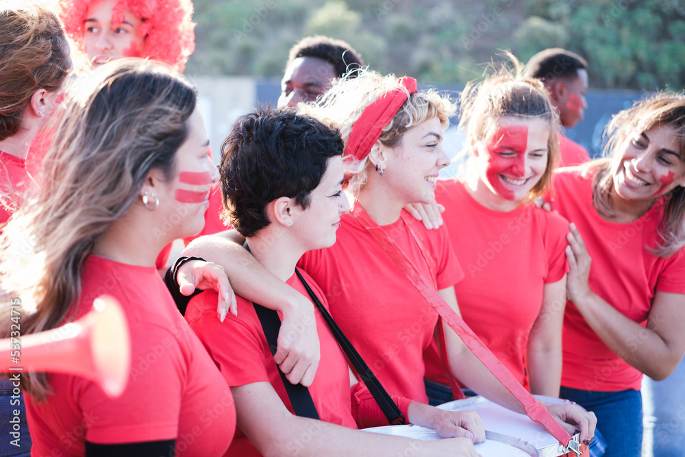 Obraz premium Group of soccer team fans together cheering and having a good time outdoors