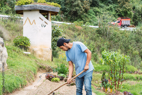 Latin man tilling the land in the rural countryside.