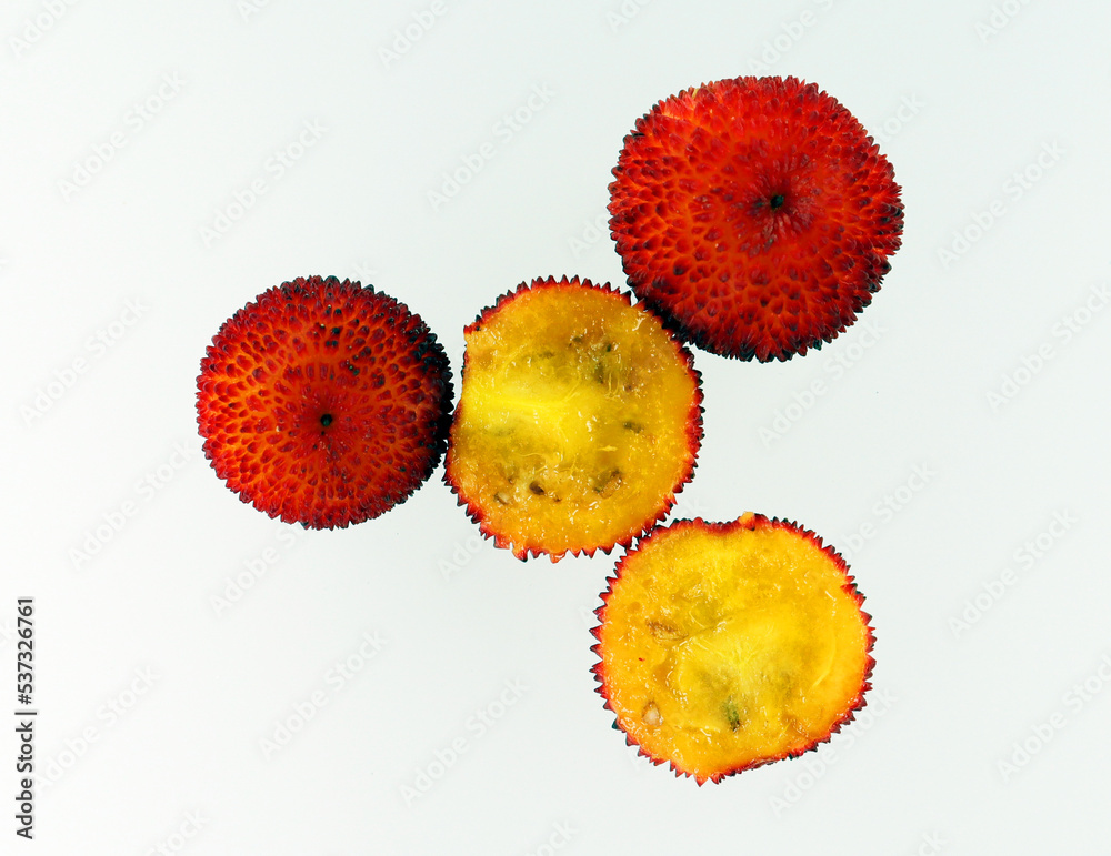 Red round strawberry fruit Arbutus close-up isolated on white, unusual shape, symbol of Madrid Red round strawberry fruit Arbutus close-up isolated on white, unusual shape, symbol of Madrid