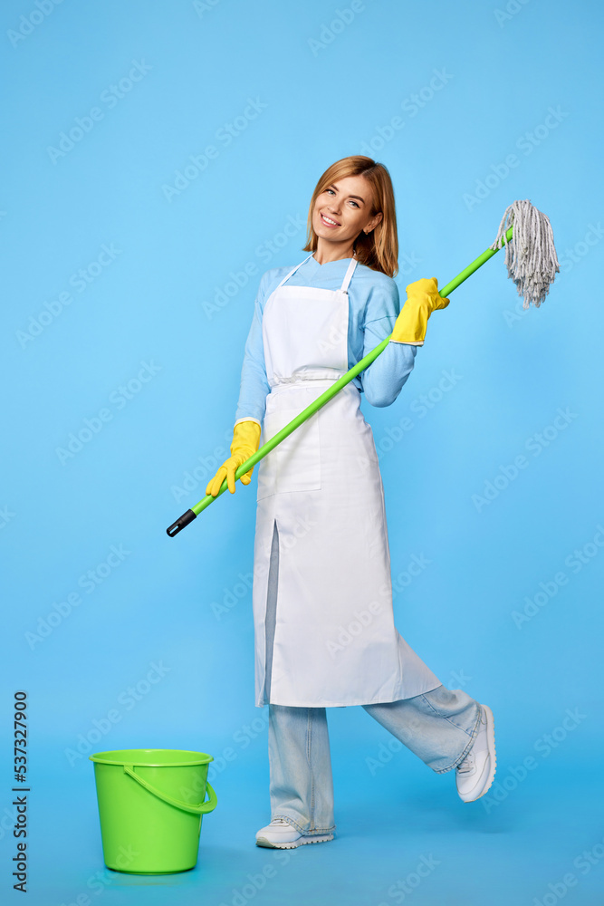 woman in rubber gloves and cleaner apron washing floor with mop woman in rubber gloves and cleaner apron washing floor with mop