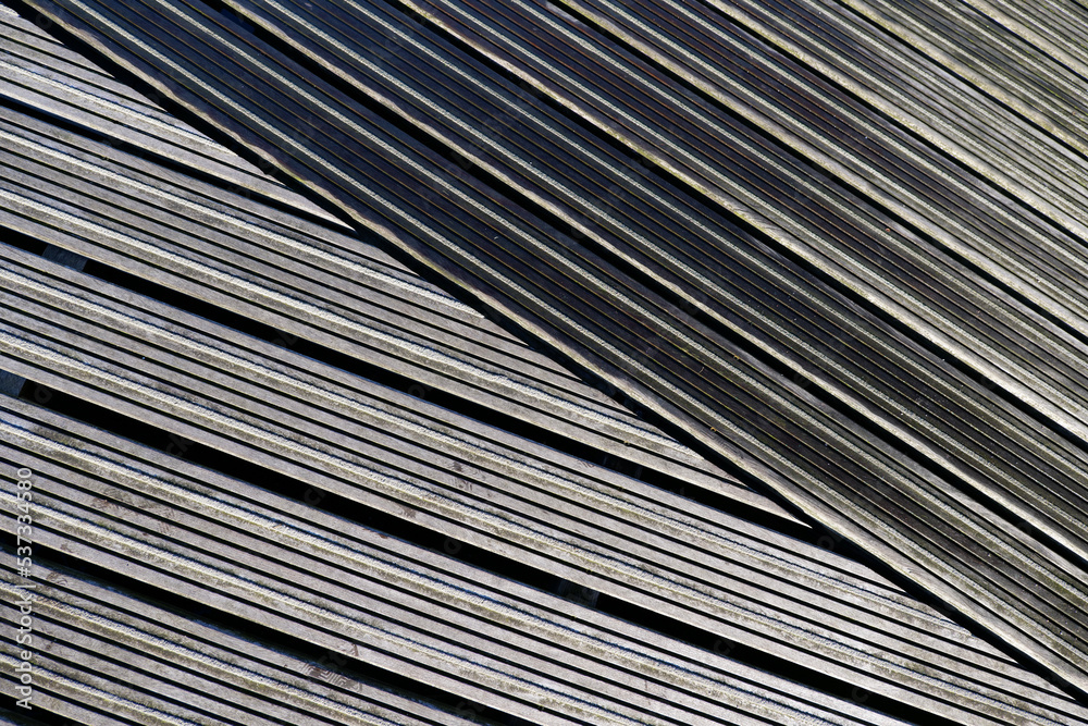 Abstract wooden texture. Abstract texture slide background. Diagonal texture. Abstract peaceful picture of wooden plants on a terrace. Tranquille scene of diagonal lines with little color. 
