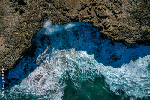 Waves that break on the volcanic coast of the island, top view