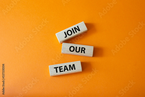 Join our team symbol. Wooden blocks with words Join our team. Beautiful orange background. Business and Join our team concept. Copy space.
