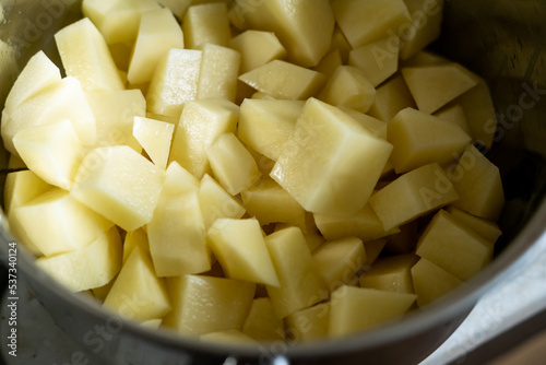 Chopped raw potatoes in a bowl. Cooking boiled potatoes.