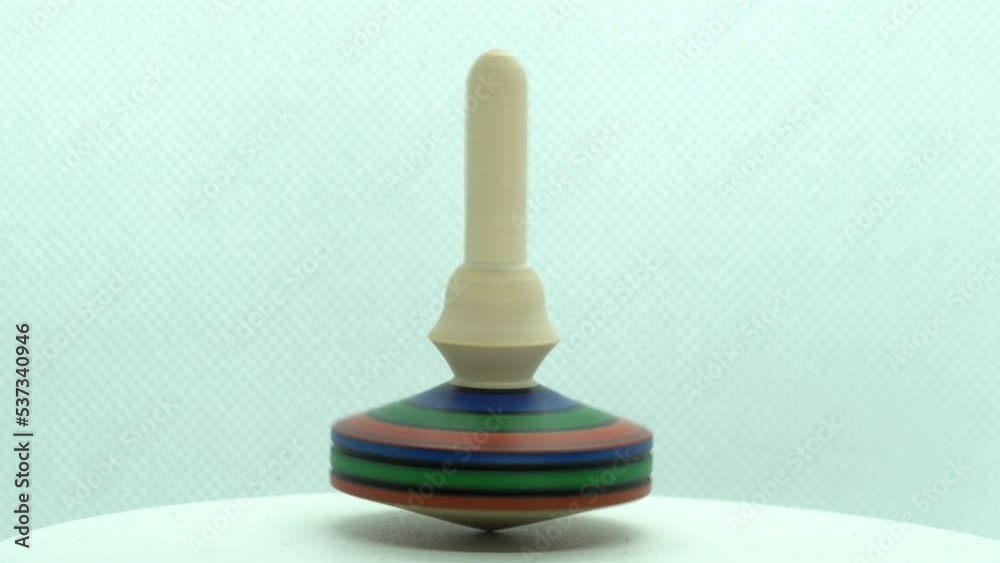 wooden Spinning top in action, toy rotating totem in motion