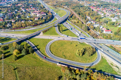 Highway multilevel crossing. Spaghetti junction on A4 international highway with Zakopianka road and railway, the part of freeway around Krakow, Poland. Aerial view from above