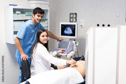 Doctor examining patient with ultrasound scan