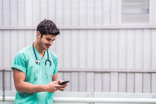 Male doctor using smartphone outdoors