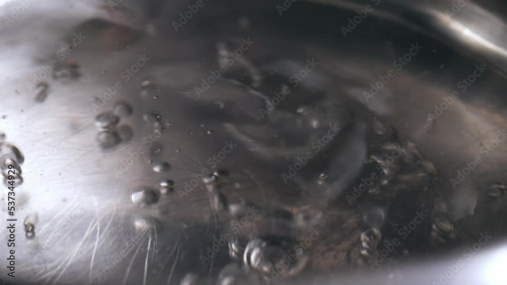 Hot water boiling in saucepan 