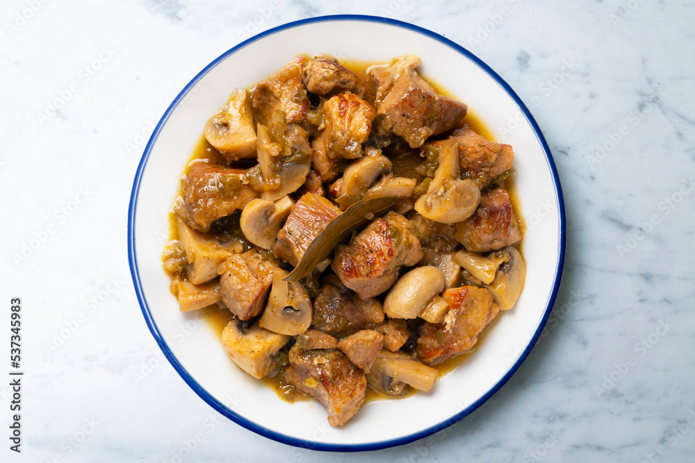 Braised pork with red wine sauce and mushrooms. Traditional northern Spanish tapas. Braised pork with red wine sauce and mushrooms. Traditional northern Spanish tapas.