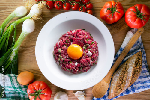 Traditional steak tartare with beef and egg yolk.