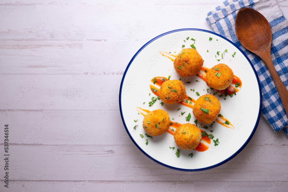 Tapa of Iberian ham croquettes. Recipe made with bechamel sauce and ham, all battered and fried in the shape of round balls. Tapa of Iberian ham croquettes. Recipe made with bechamel sauce and ham, all battered and fried in the shape of round balls.