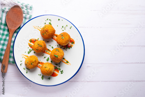 Tapa of Iberian ham croquettes. Recipe made with bechamel sauce and ham, all battered and fried in the shape of round balls.