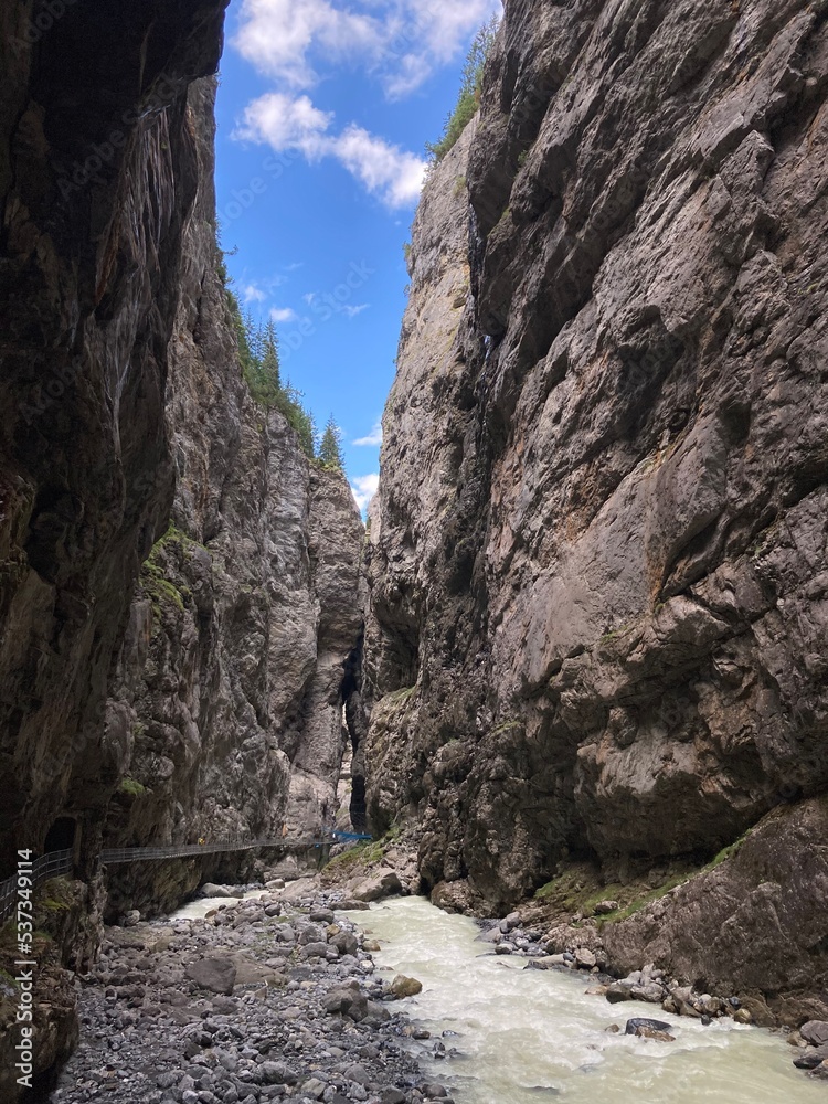 Canyon in Switzerland Europe Grindelwald. Big rocky canyon in Switzerland with river on the bottom and waterfalls. Switzerland landscape in the summer sunny day. Nature canyon landscape with the trees