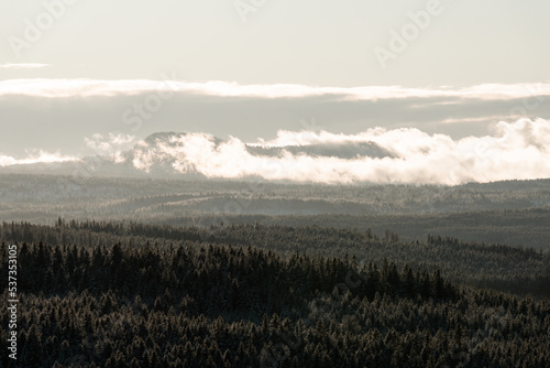Misty forest and mountains, sunset at Sumava national park