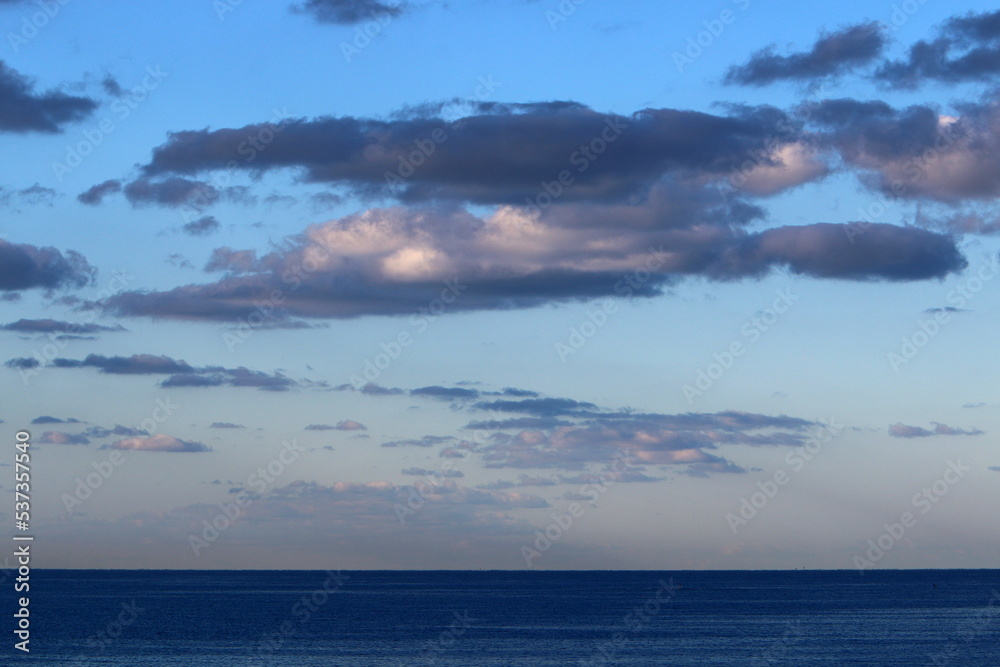 Large rain clouds in the sky over the sea.