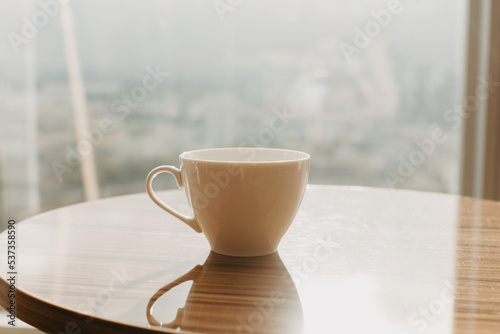 White cup on the background of the window.