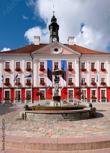 PicturesqueTown Hall building in Tartu, Estonia. Town main square with round classical fountain.