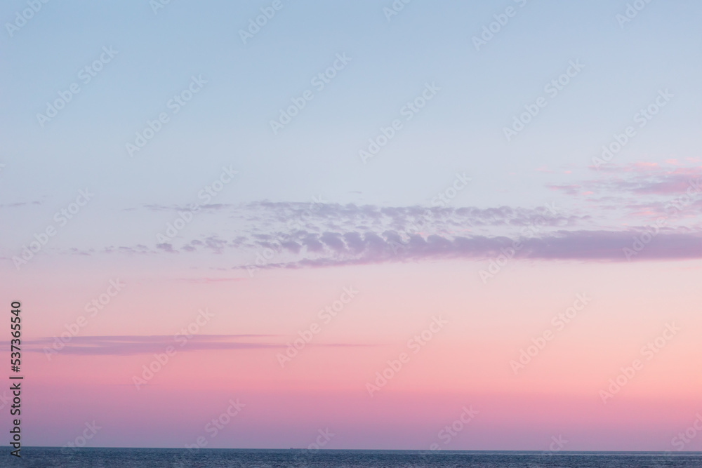 Purple-pink twilight sky and ocean on the horizon. Copy space. Background template. Time after sunset Purple-pink twilight sky and ocean on the horizon. Copy space. Background template. Time after sunset