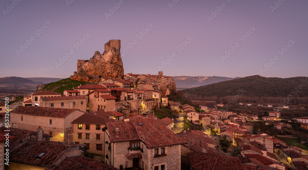 Panoramic landscape of the medieval village of Frías with old stone buildings and castle in the tophill at sunset, Burgos, Castile and Leon, Spain