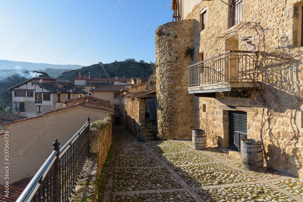 Cityscape with old, stone buildings at winter in picturesque medieval town of Frias, Burgos, Spain
