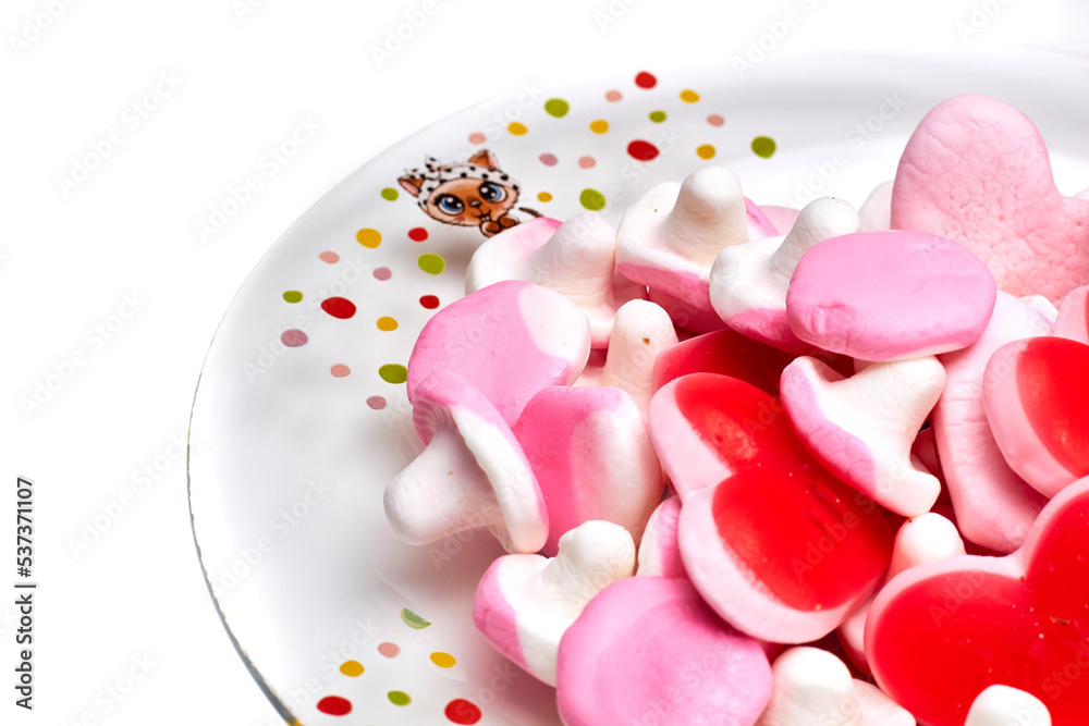 Candy red hearts on a plate isolated Candy red hearts on a plate isolated