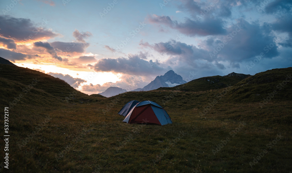 Camping Tent near Bachalpsee in the mountains of Switzerland, Night and Sunset in Swiss Alps