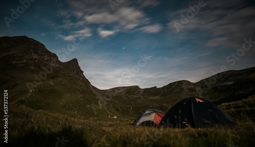 Camping Tent near Bachalpsee in the mountains of Switzerland, Night and Sunset in Swiss Alps