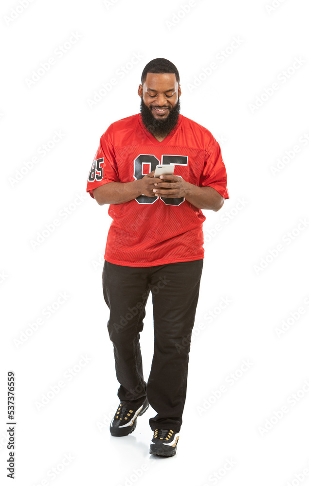 Fan: Man In Sports Jersey Using Cell Phone Fan: Man In Sports Jersey Using Cell Phone