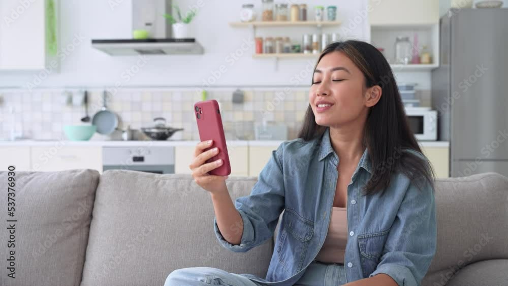 Young asian woman making video calling with smartphone at home Young asian woman making video calling with smartphone at home