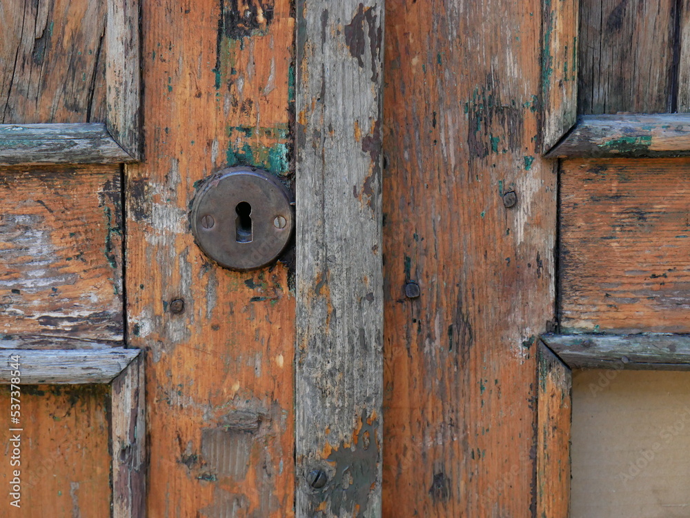 close-up on the door, old and wooden, structural elements, slats and the keyhole plate for the lock close-up on the door, old and wooden, structural elements, slats and the keyhole plate for the lock