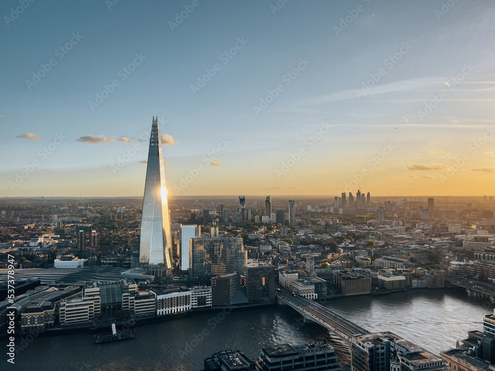 Aerial view on the Shard tower in central London with river Thames and bridge during sunset
