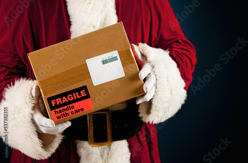 Obraz na plátně Santa: Getting Ready to Ship Package