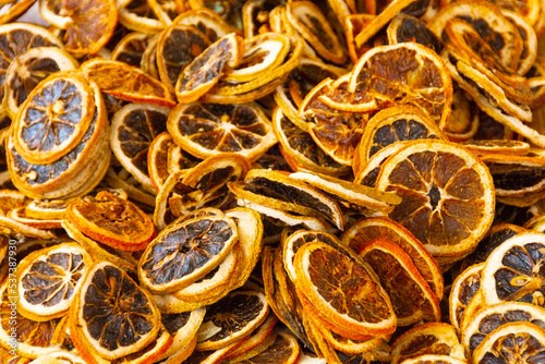 Texture of dried sliced citrus fruits on the market stall. Oranges, lemons, grapefruits.
