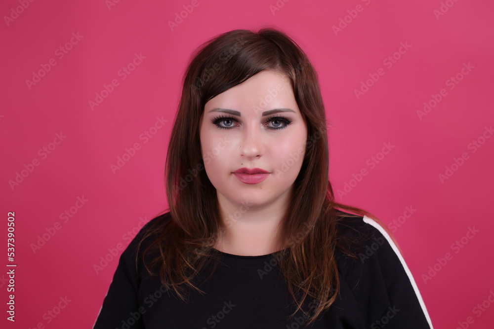 beautiful fashionable young plump fat big oversize girl model on the studio with piercings in a black t-shirt and jeans beautiful fashionable young plump fat big oversize girl model on the studio with piercings in a black t-shirt and jeans