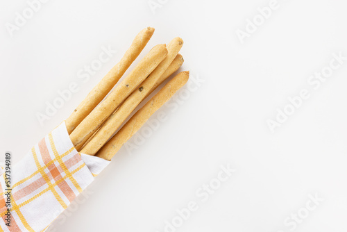 Italian Grissini Breadsticks with olive pieces on white background
