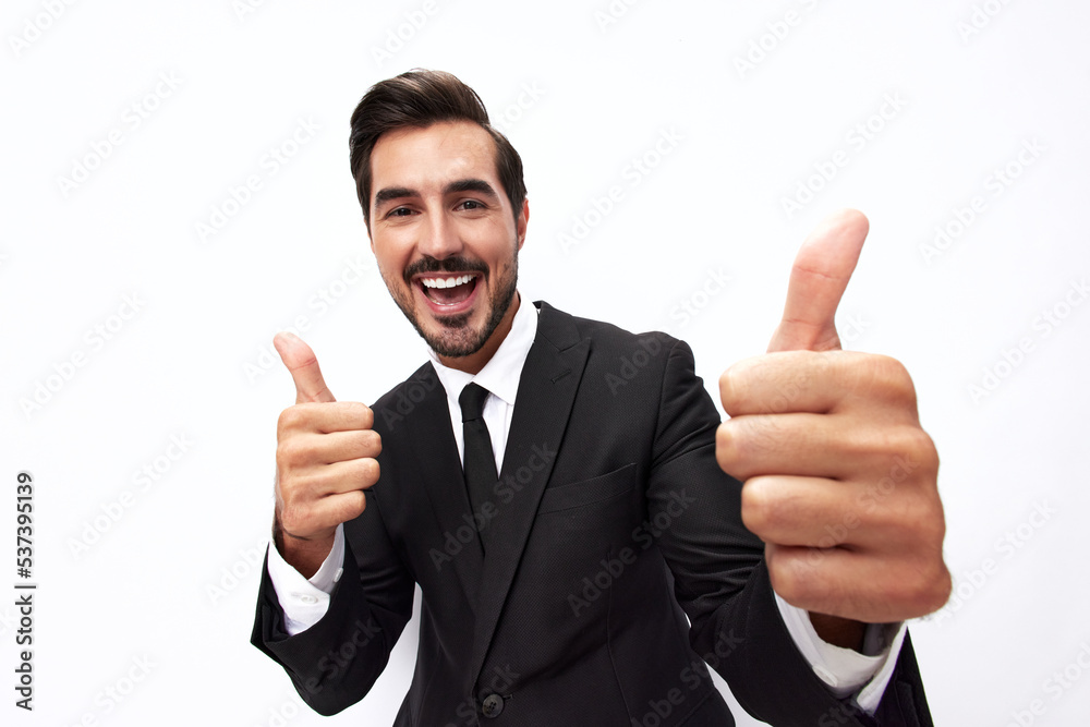 Portrait of a man in an expensive business suit close-up wide-angle lens pulls his hands into the camera with open mouth surprise happiness and shows thumbs up on white background, copy space Portrait of a man in an expensive business suit close-up wide-angle lens pulls his hands into the camera with open mouth surprise happiness and shows thumbs up on white background, copy space