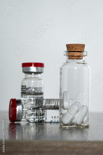 Medicines for the treatment of the pandemic on a wooden table.