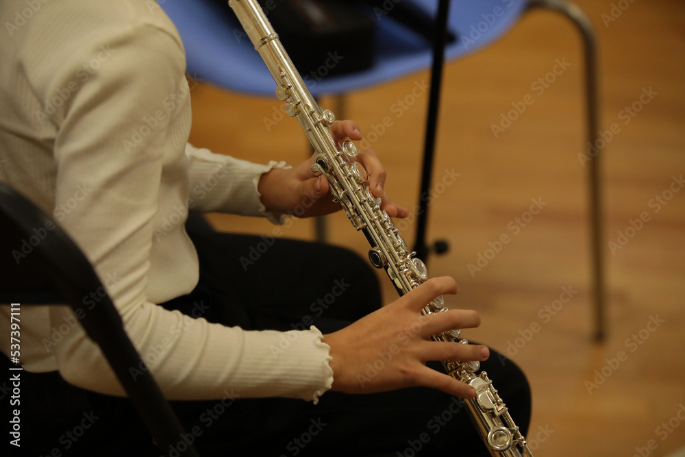 Naklejka premium A girl playing the flute
