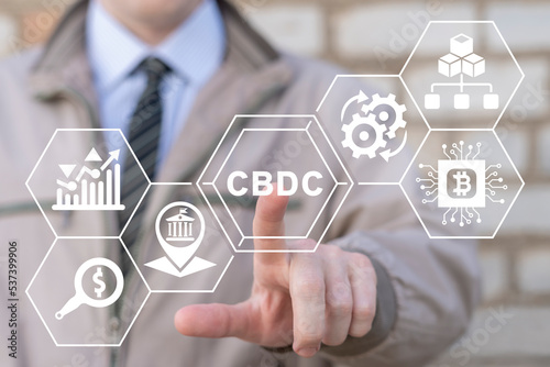 Businessman using virtual touchscreen presses abbreviation: CBDC. Concept of CBDC - Central Bank Digital Currency. Business technology, financial, blockchain, exchange, smart money and digital asset.